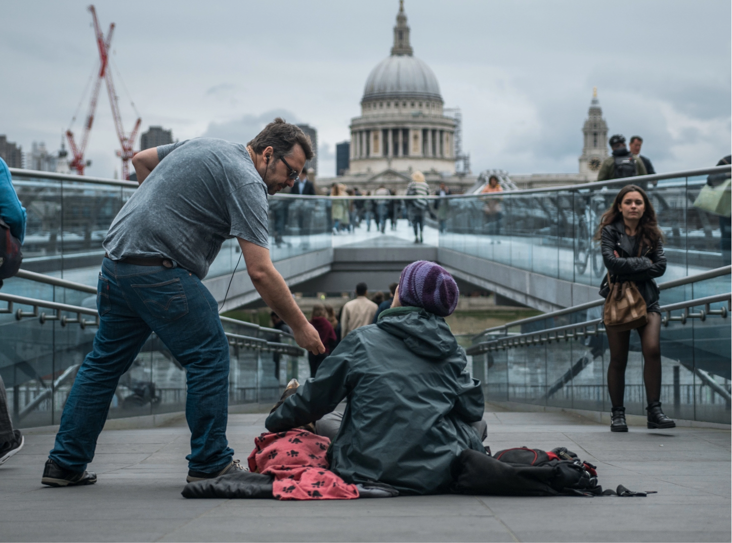 man helping homeless person outside for health in place