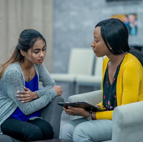 EmPATH Unit employee speaking with psychiatric patient in the ER