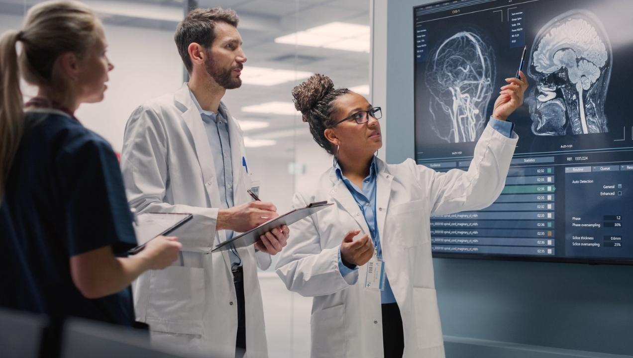 Teneurology image of doctors and medical staff reviewing diagnostic imaging