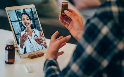 Physician talking with patient through video call on tablet