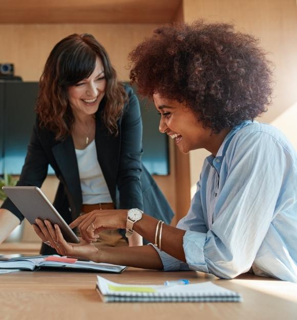 Image of two female Vituity employees working in an office setting